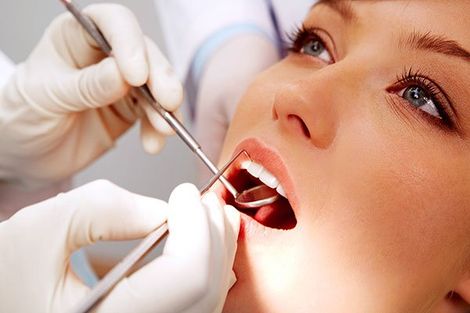 Dental Work — Dentist Checking Patient Teeth in Mansfield, OH