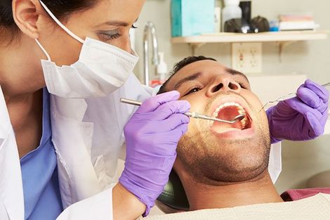 Loose Teeth — Dentist Checking Man Teeth in Mansfield, OH