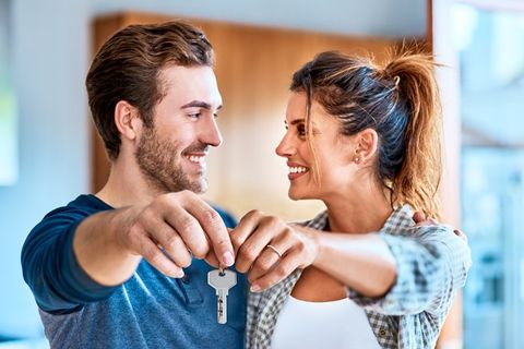 A couple holding keys to their new home