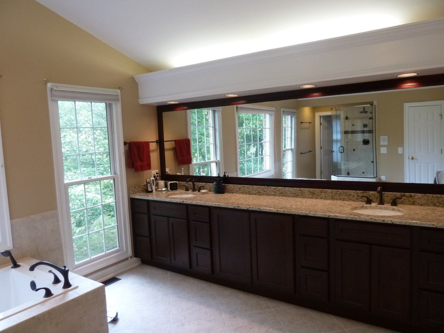 A bathroom with two sinks and a large mirror
