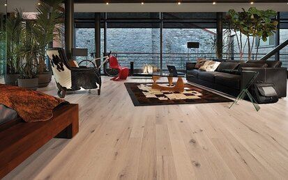 A living room with a couch , chairs , and a piano.