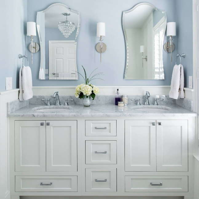 A bathroom with two sinks and two mirrors