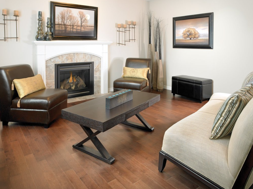 A living room with a fireplace couch and chairs