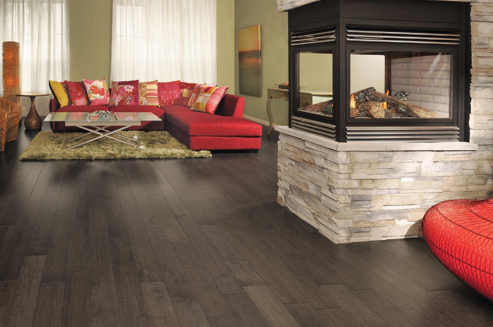 A living room with a fireplace and a red couch