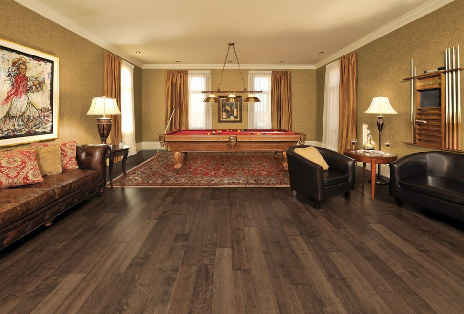 A living room with a pool table and a couch