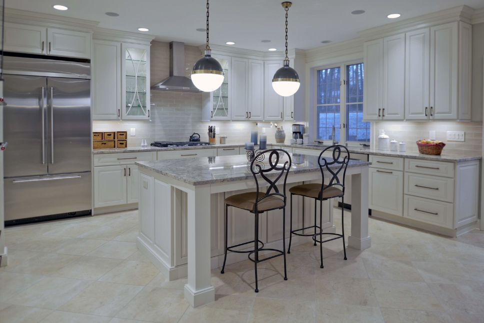 A kitchen with white cabinets and stainless steel appliances