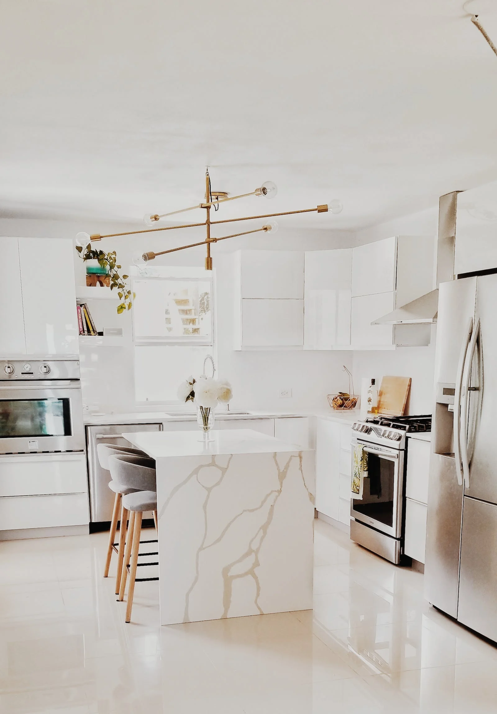 A kitchen with white cabinets and a large island in the middle