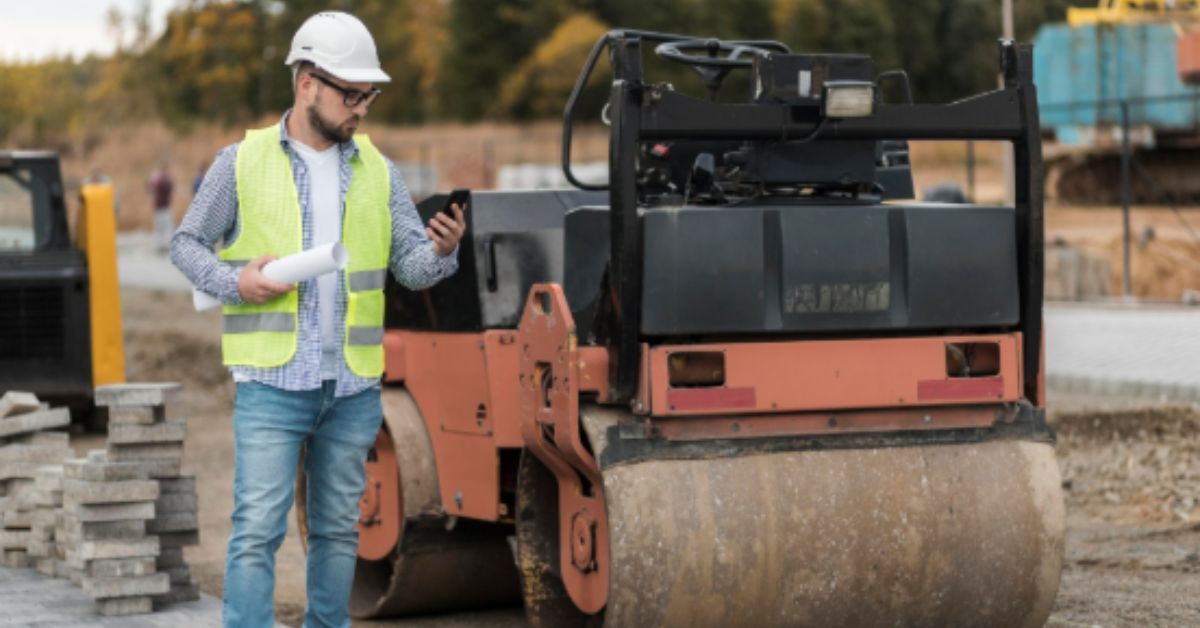 Worker inspecting site plans during commercial asphalt services in Lee’s Summit, MO, .