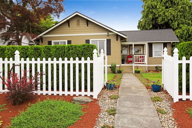 One-story house with a white picket fence