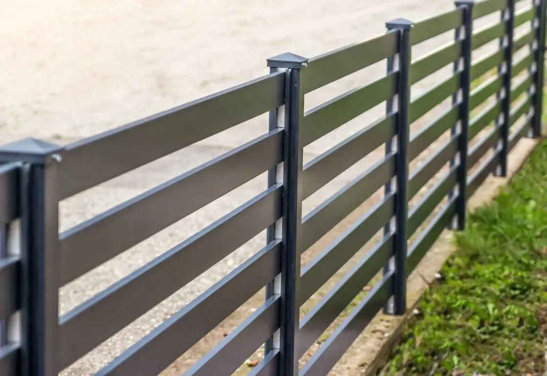 Close-up of a dark horizontal aluminum fence