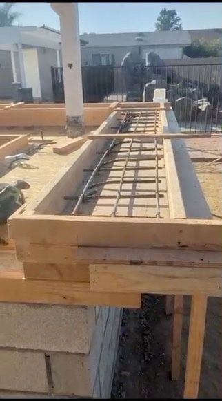 Wooden formwork with rebar reinforcement for a concrete structure, outdoors.