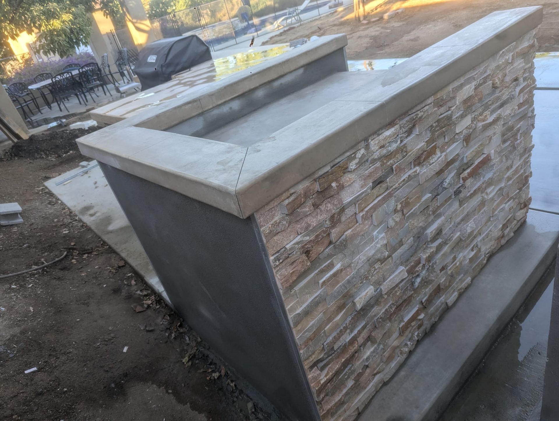 Outdoor stone and concrete bar under construction.