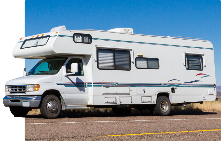 A white rv is parked on the side of the road