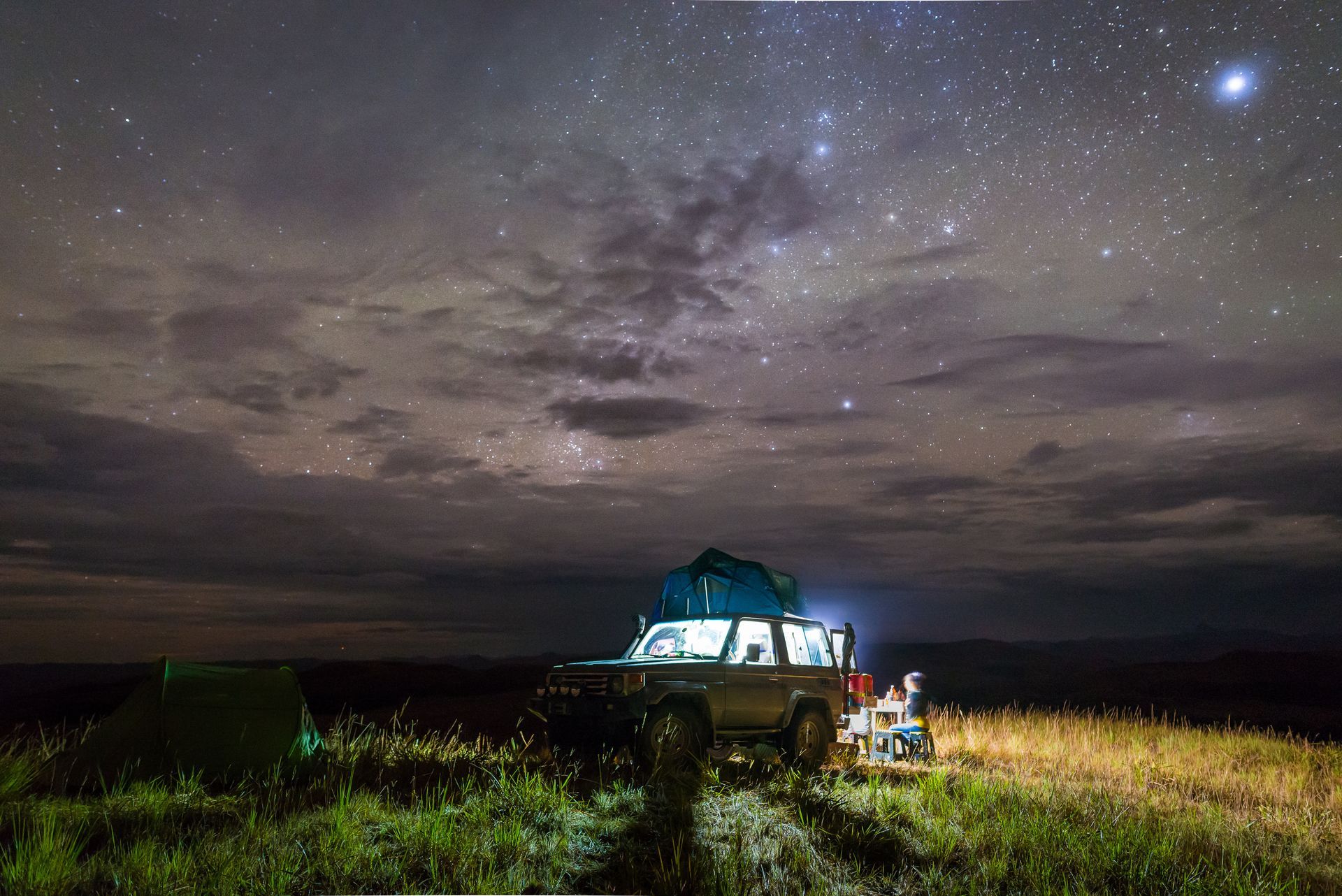 An overlanding rig under the night sky