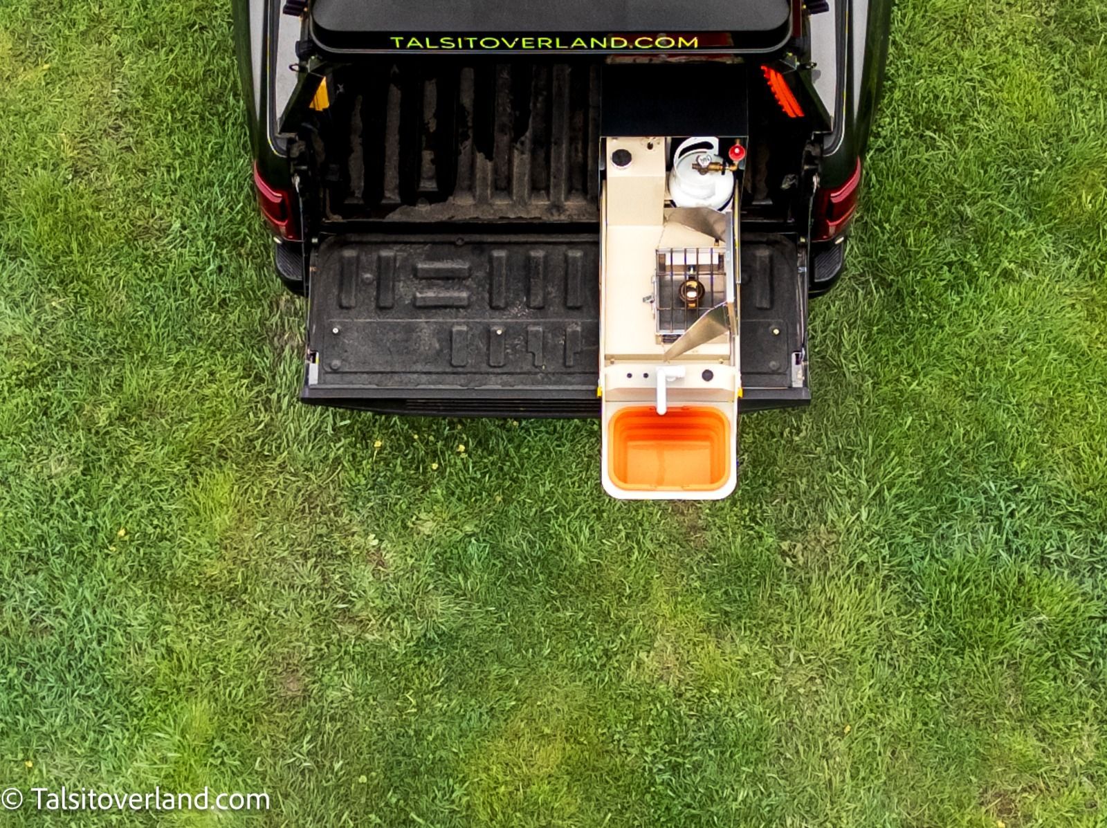 Retractable Minerva overland kitchen on vehicle tailgate. 