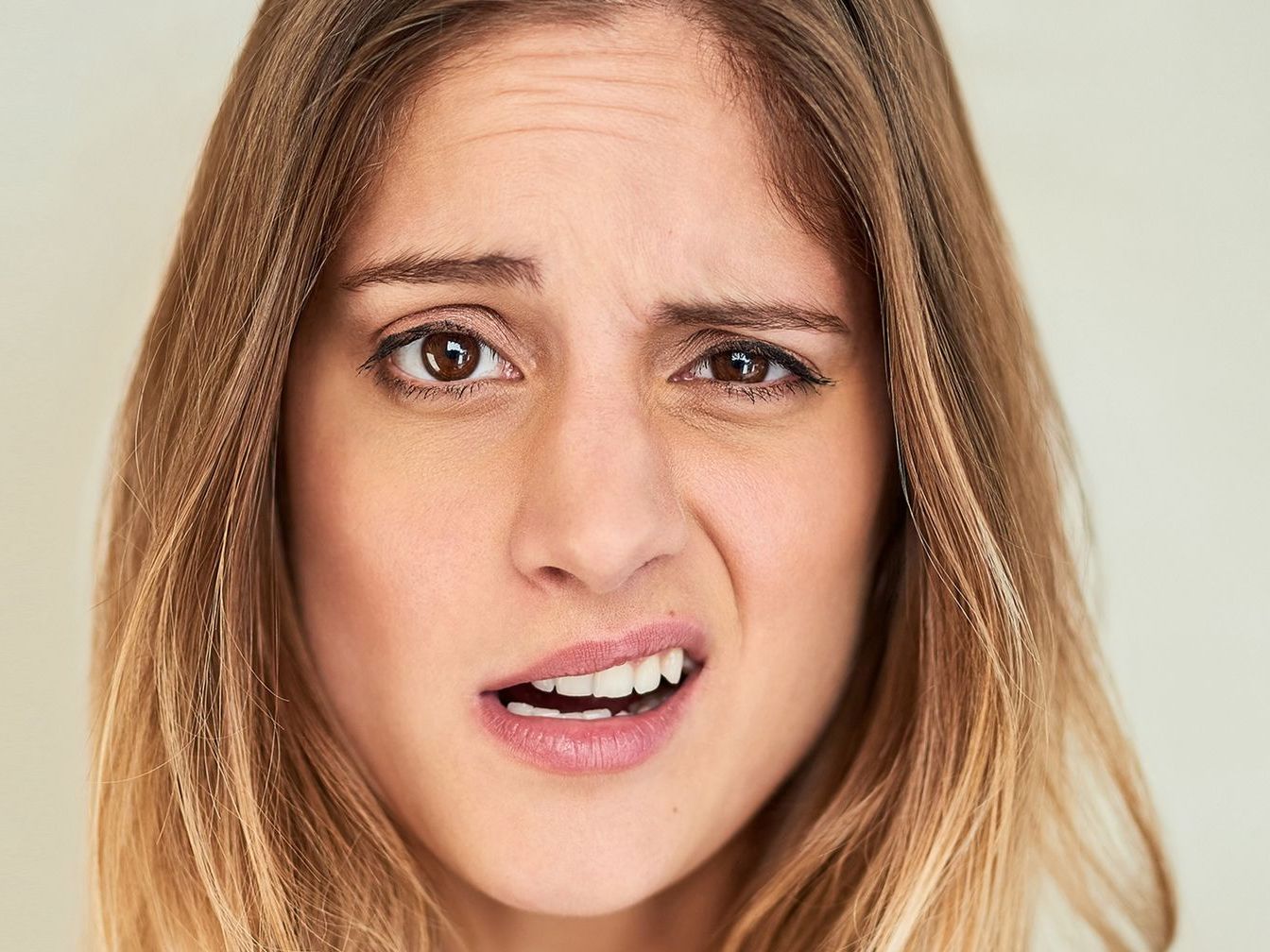 A woman is making a face with her mouth open.