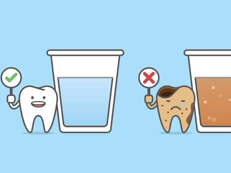 A tooth is holding a sign next to a cup of water.