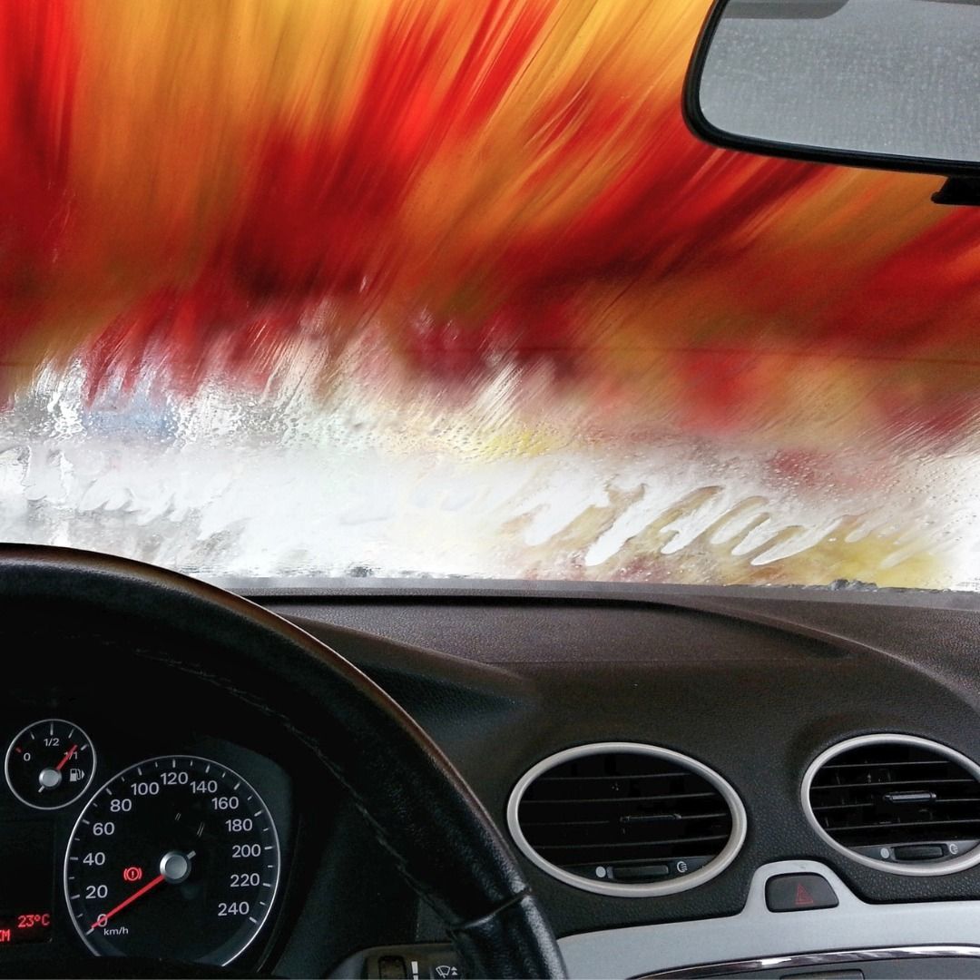 A car is going through a car wash and the dashboard is shown