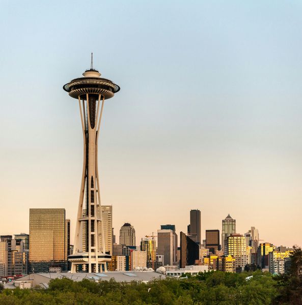 Seattle skyline with the Space Needle against a sunset sky.
