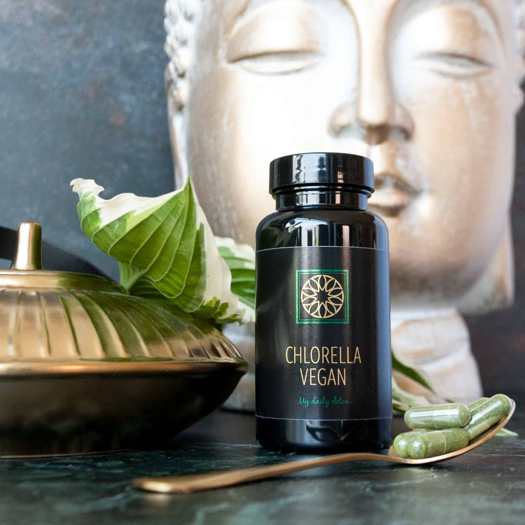 Een fles chlorella vegan naast een lepel capsules