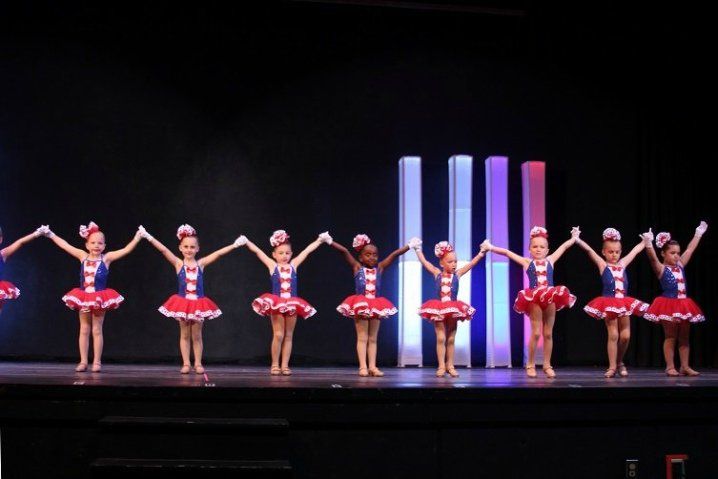 Eight dancers getting ready to bow