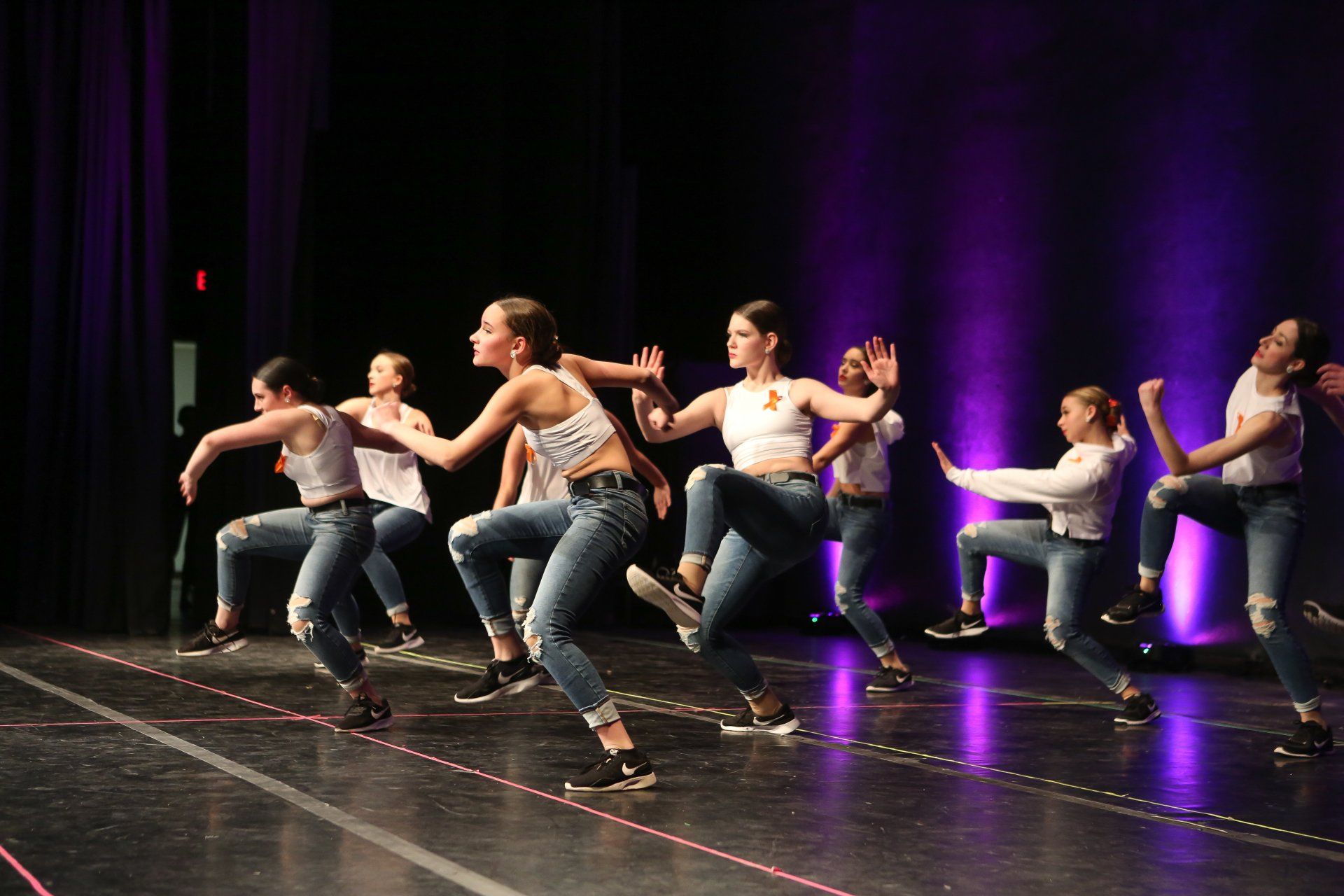 Seven dancers in mid stance at Dance Expression dance arts