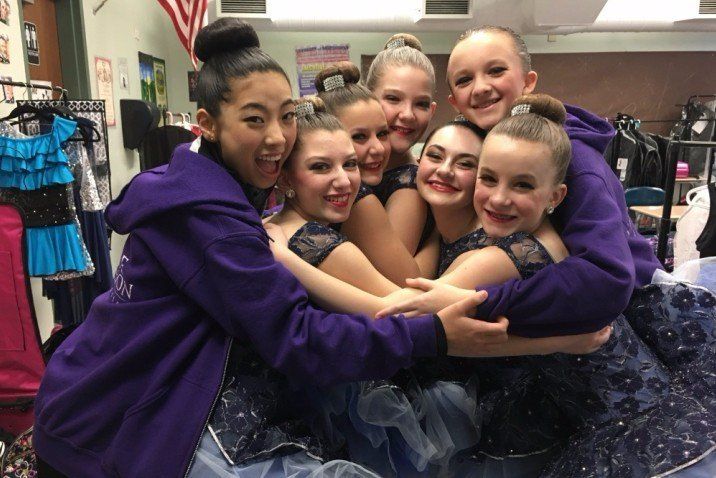 Seven Dancers hugging backstage