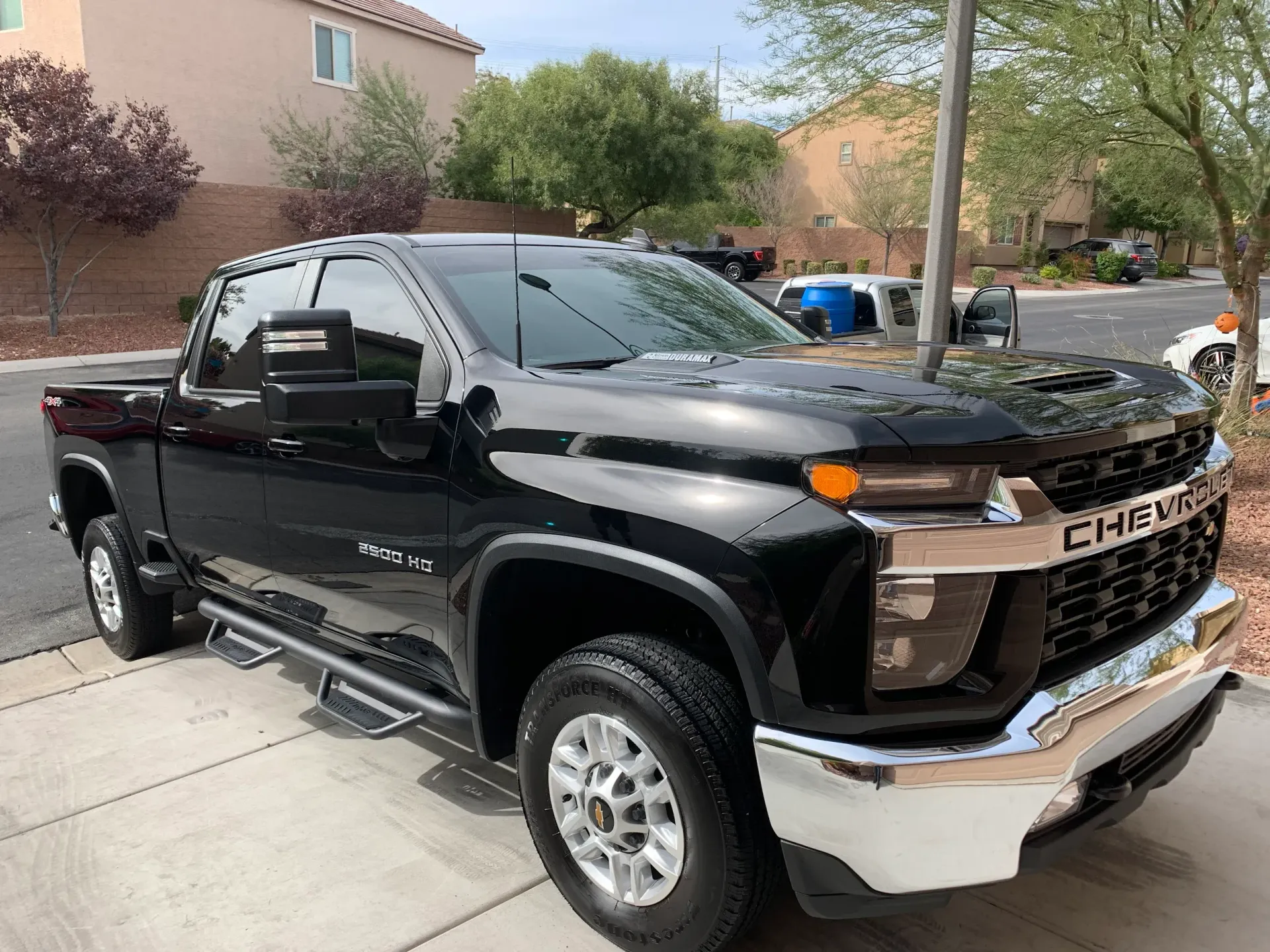 A black chevrolet truck is parked on the side of the road.