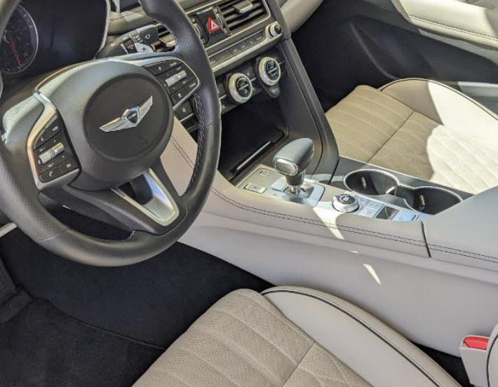 The inside of a car with a steering wheel and dashboard