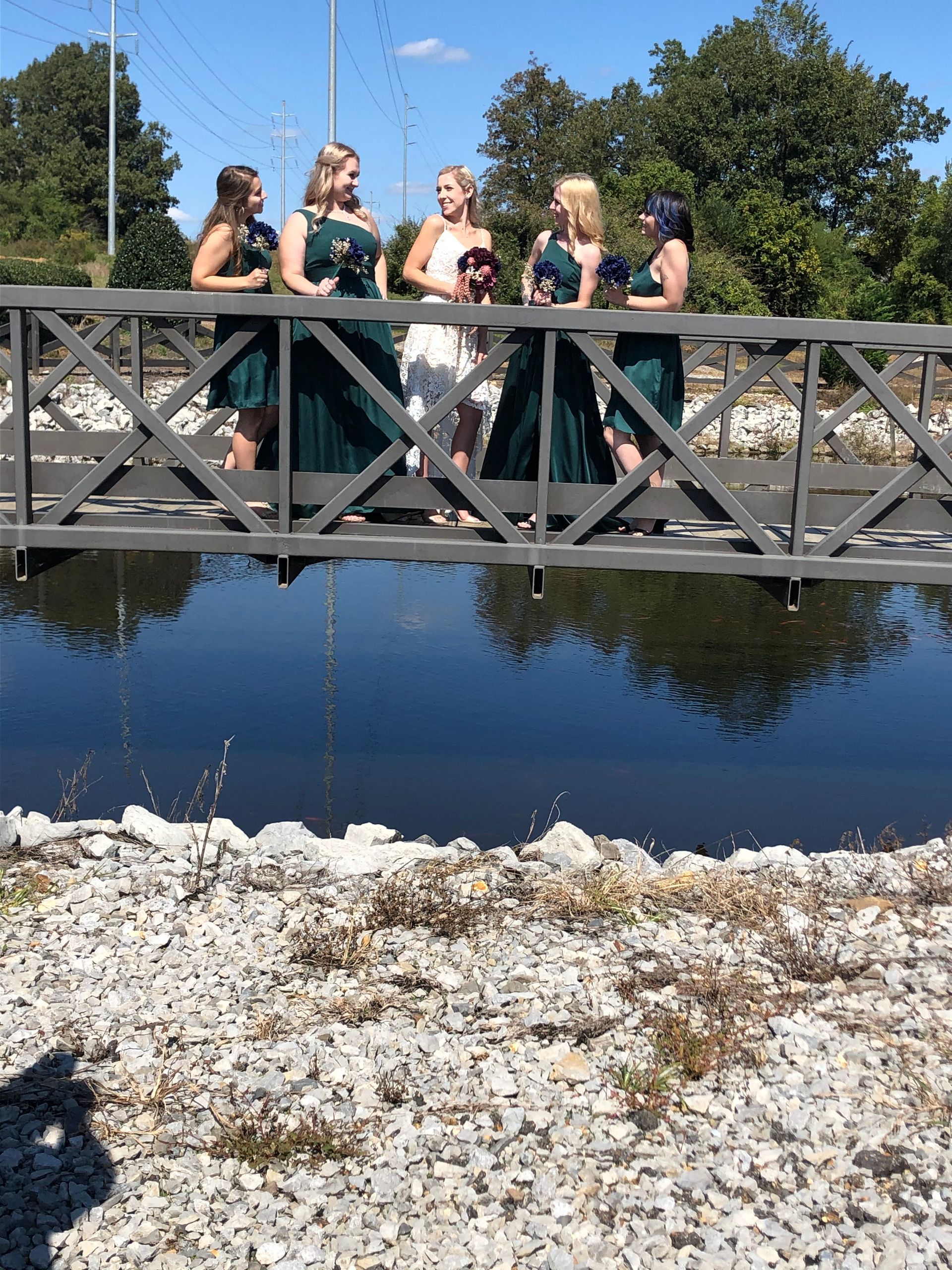 bride and bridesmaids on bridge