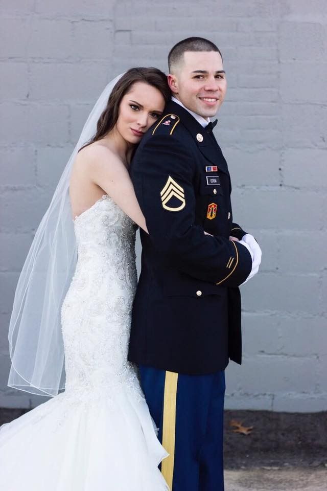 bride hugging groom in military dress uniform