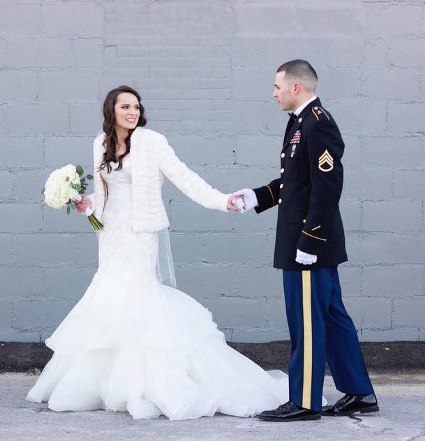 bride and groom in military dress uniform holding hands