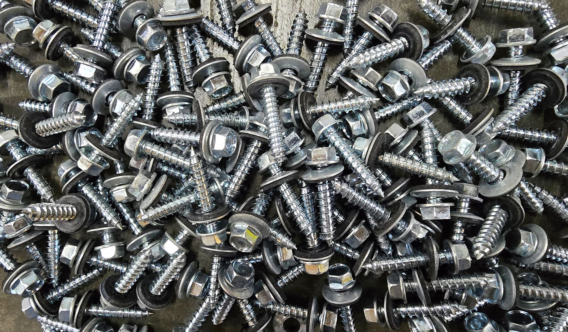 A pile of screws sitting on top of each other on a table.