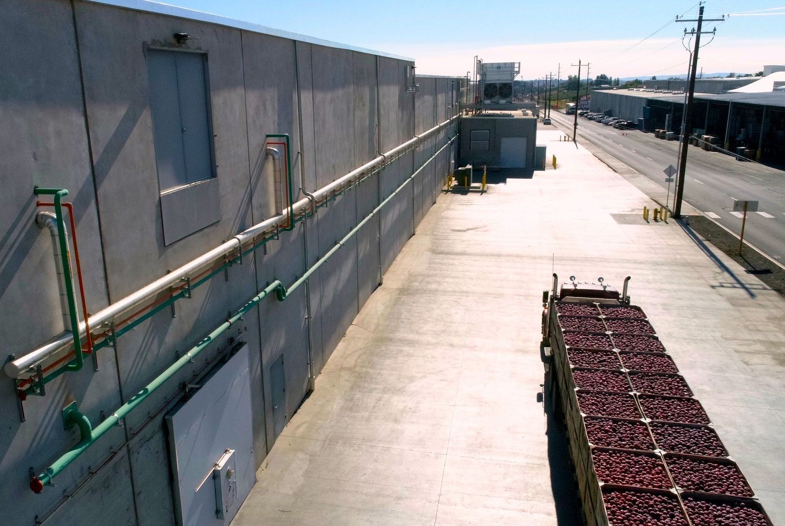 An aerial view of a warehouse with a truck full of fruit