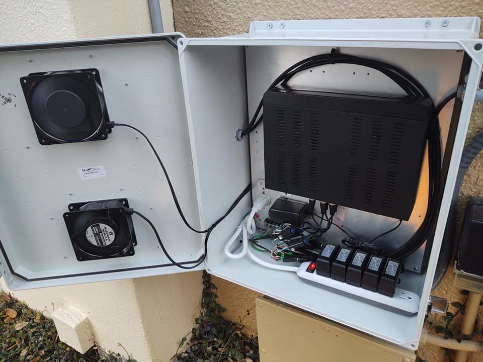 A white box with a fan and a power supply inside of it.