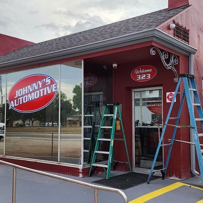 A red building with a sign that says johnny 's automotive