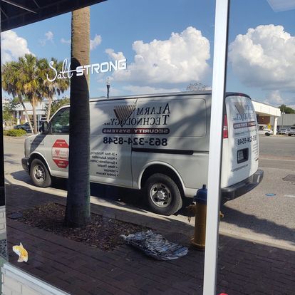 A van is parked in front of a building that says self strong