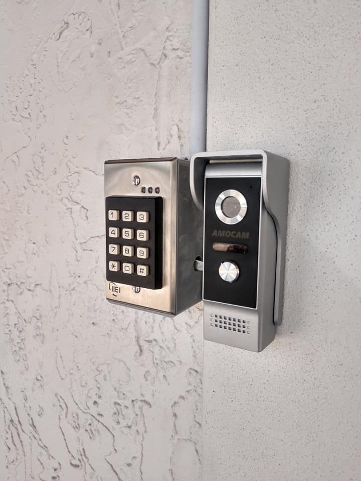 Two security cameras are mounted on a wall next to each other.