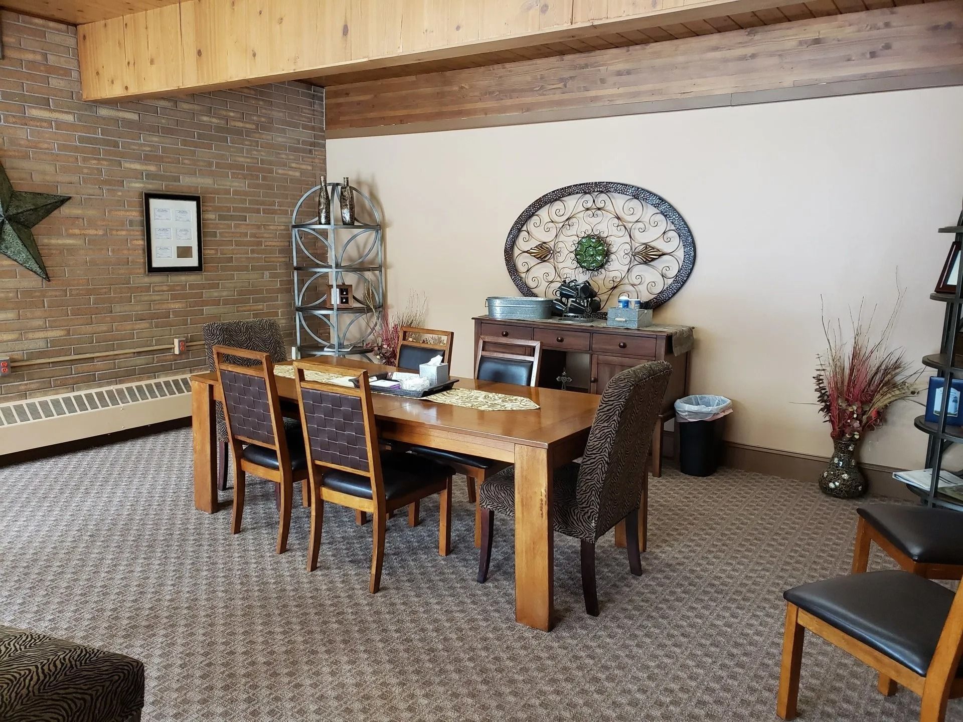 A dining room with a table and chairs and a star on the wall.