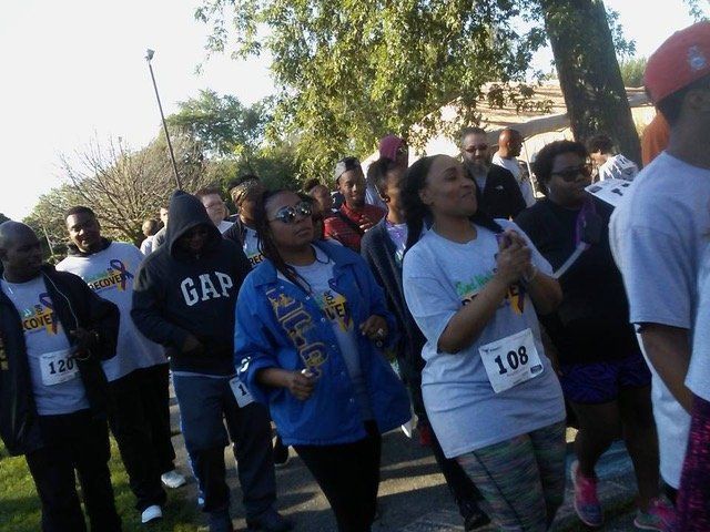 A group of people wearing gap shirts are walking down a street