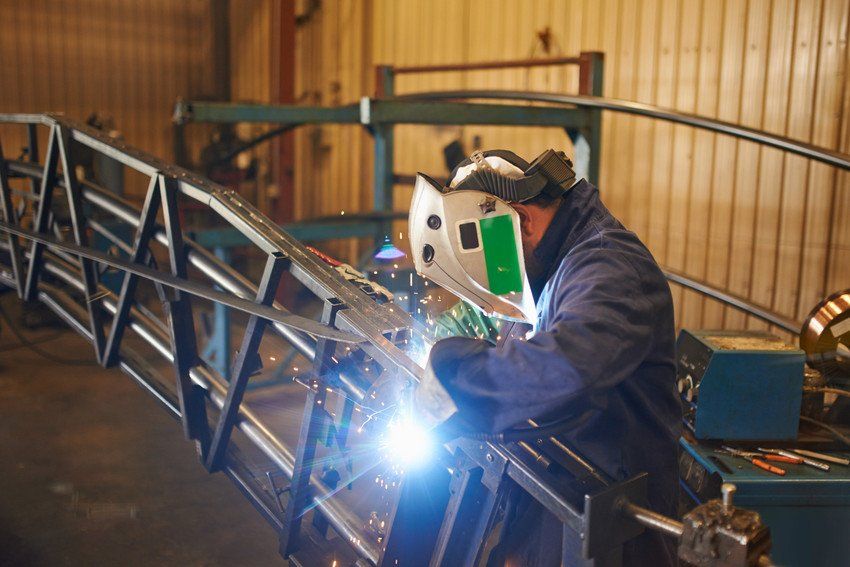 Welder using oxyacetylene torch in factory