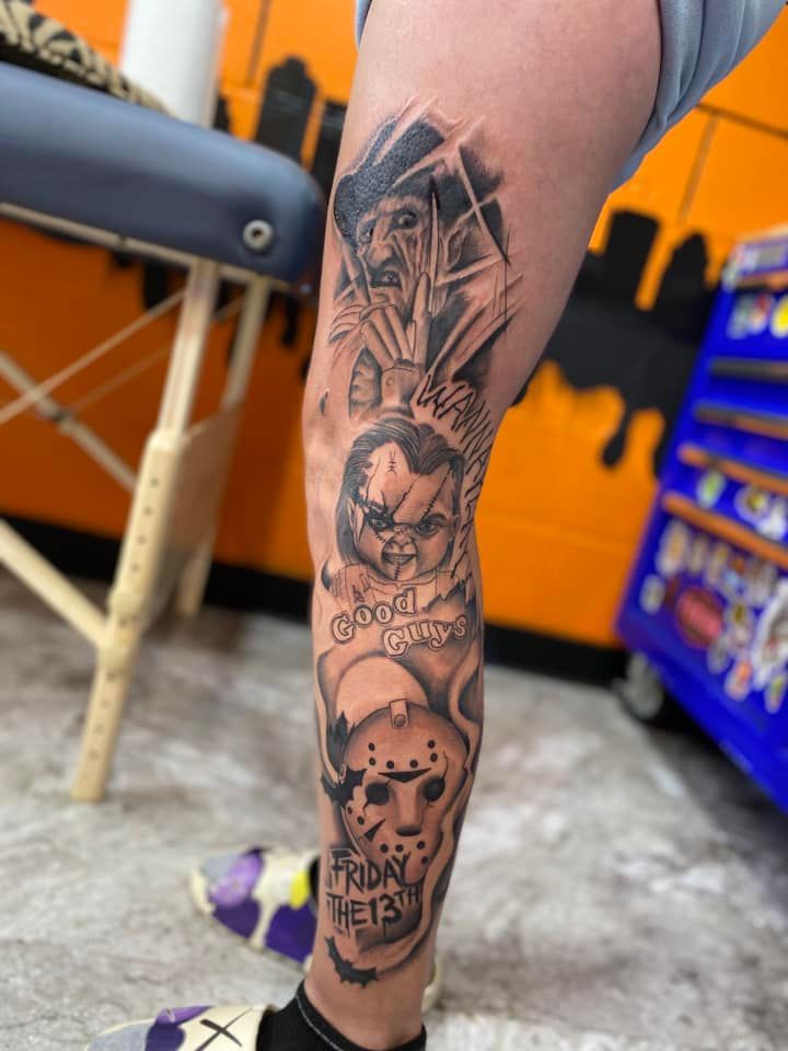 A person is getting a tattoo on their leg.