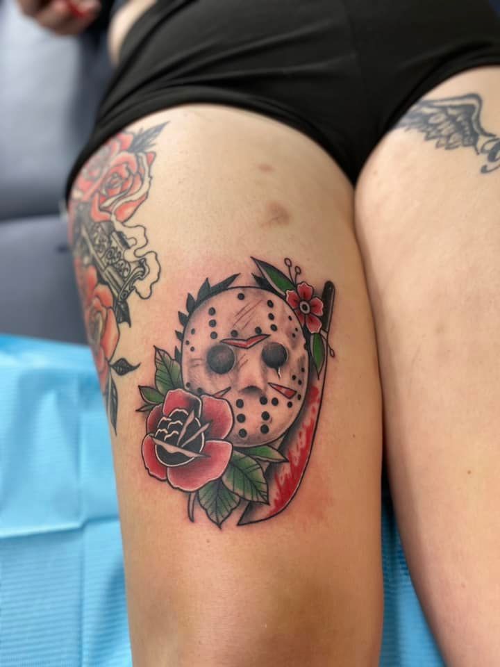 A woman has a tattoo of jason voorhees on her leg.