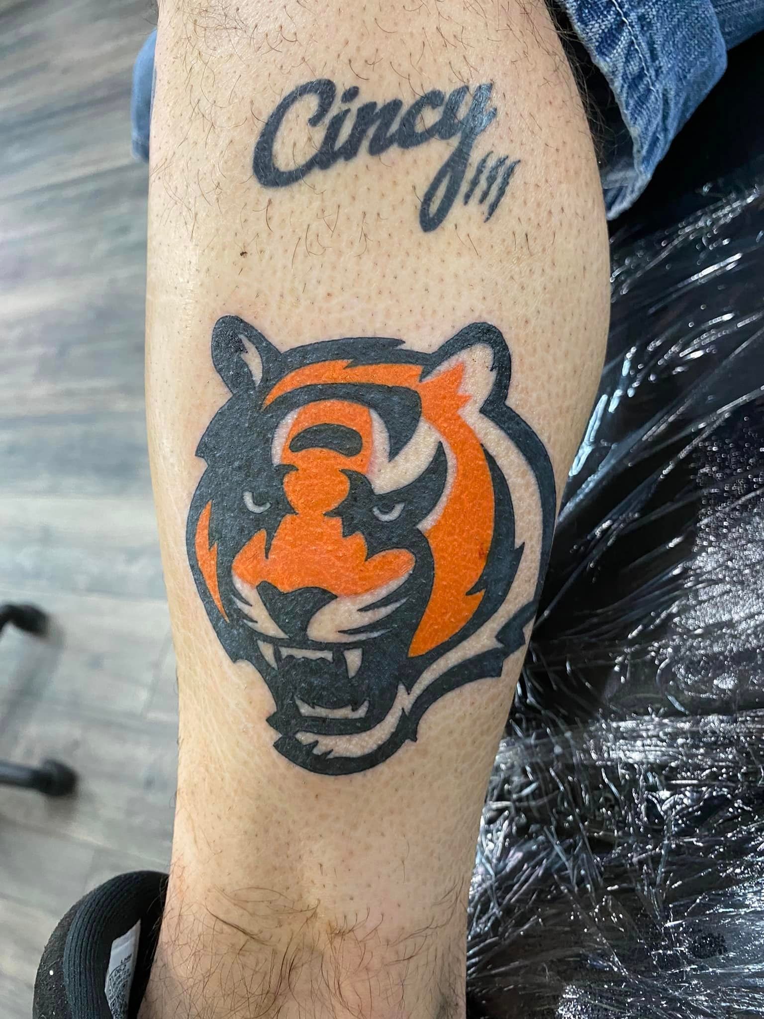 A person has a tattoo of a tiger on their leg.
