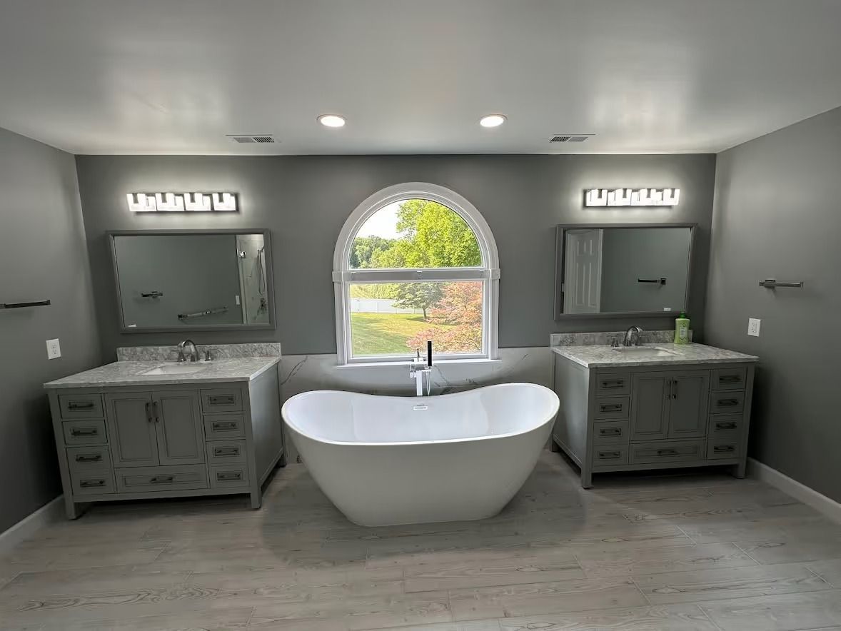 A bathroom with two sinks and a bathtub.