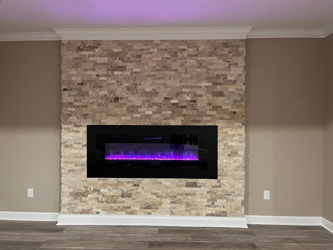Finished basement in Finksburg with LVP flooring, U-shaped wet bar, stacked stone fireplace, French glass doors, bedroom, gym, and bathroom