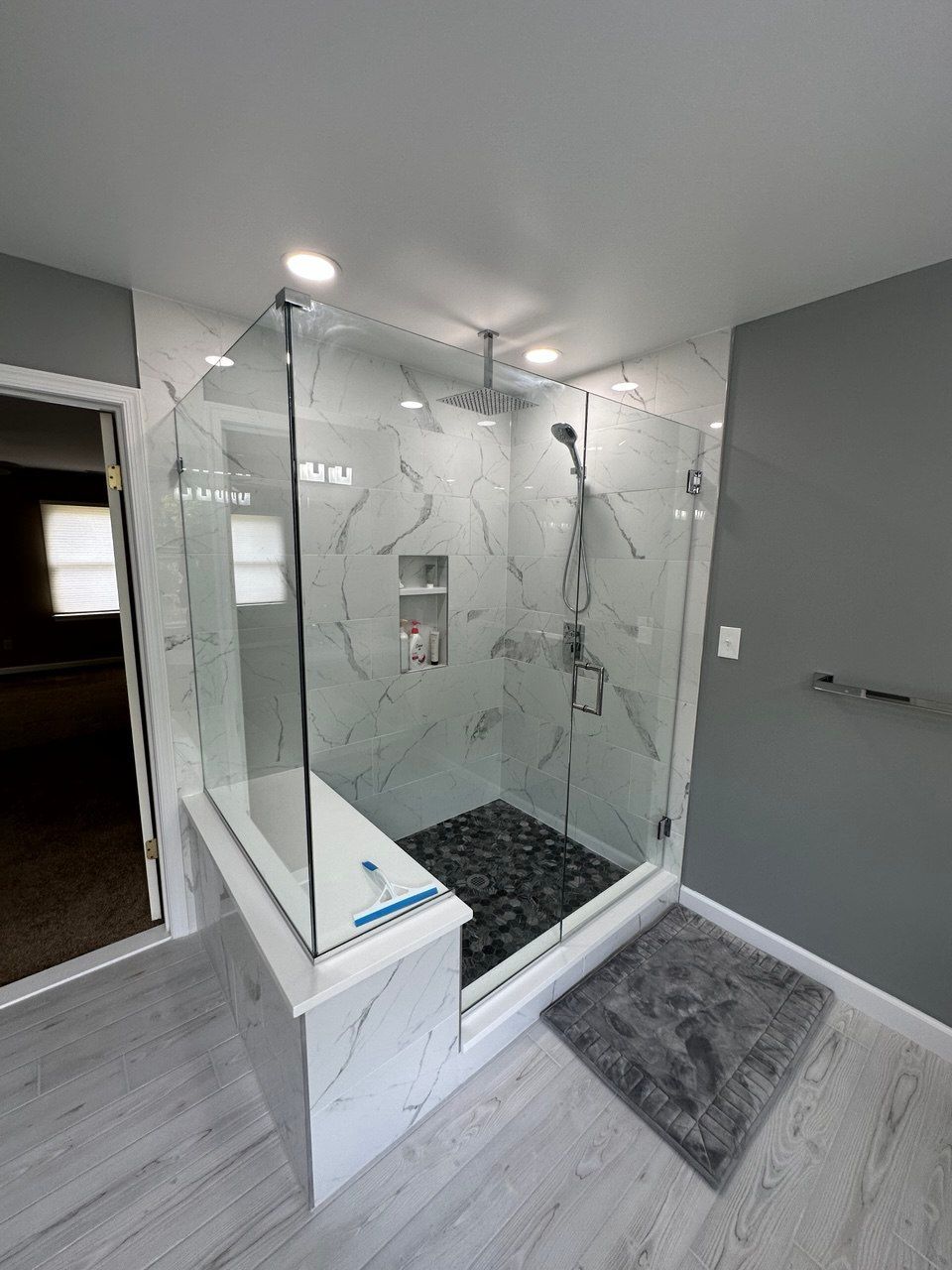 Extra-large master bathroom in Finksburg with freestanding tub under arched window, two 48-inch vanities, and large walk-in shower with bench