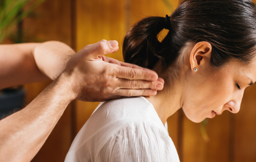A woman is getting a massage from a man in a spa.
