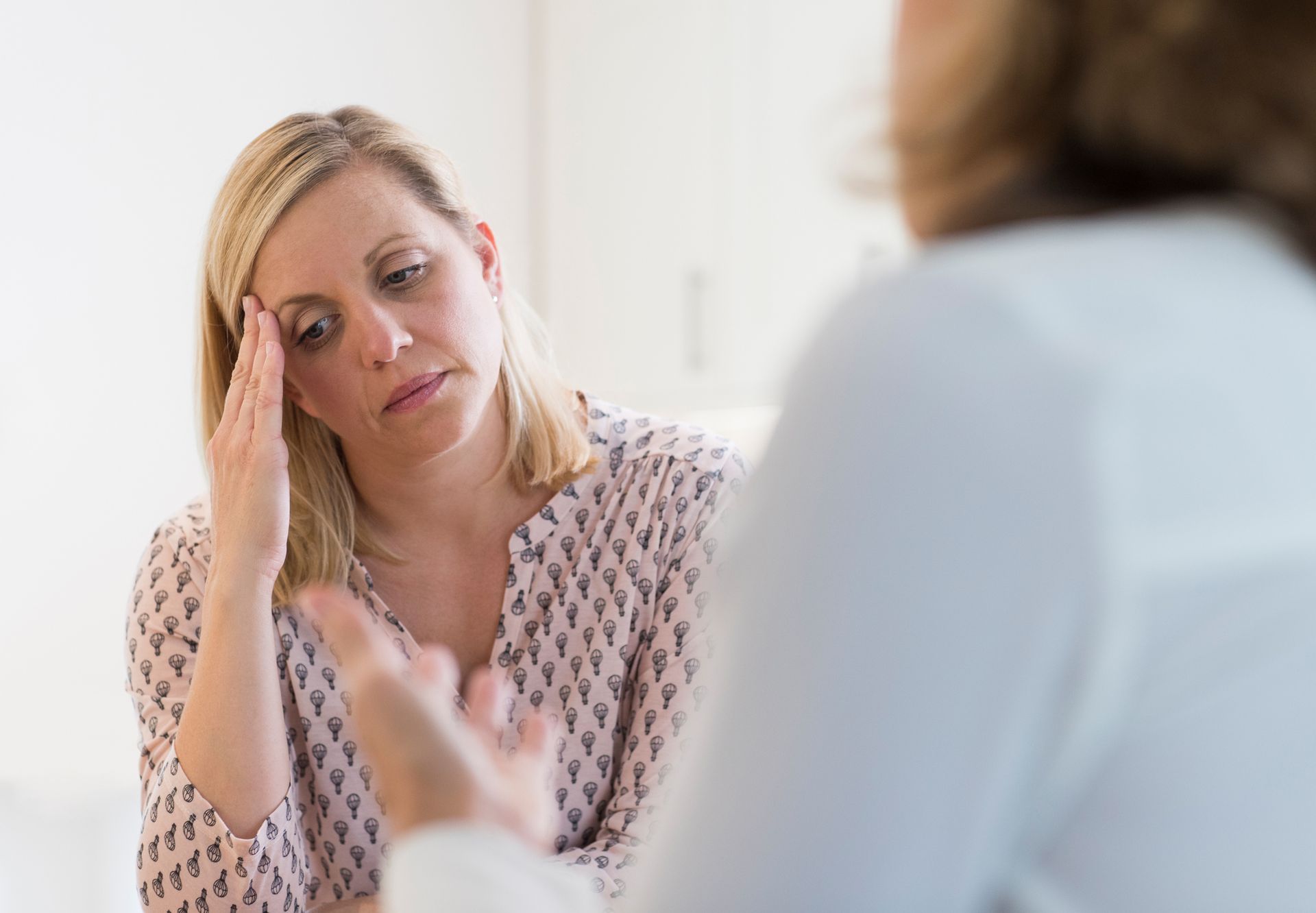 Mature woman talking to advisor, showcasing psychiatric services for mental health support.