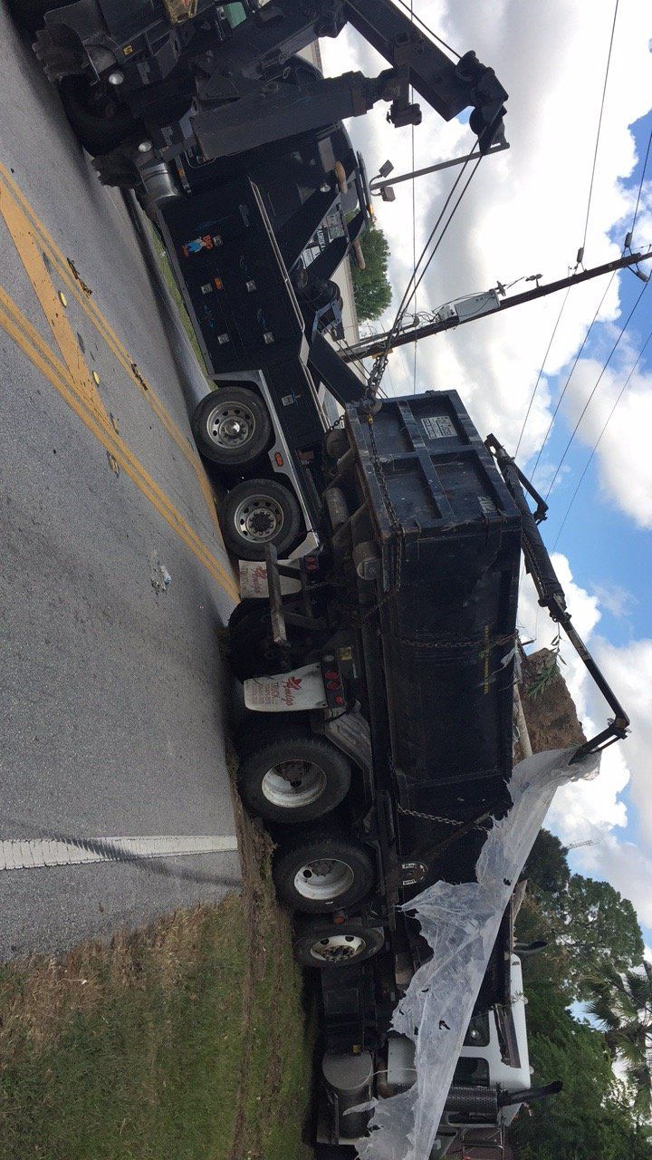 Heavy Duty Towing Vehicle — Black Heavy Duty Truck Towing a Trailer Truck in Houston, TX